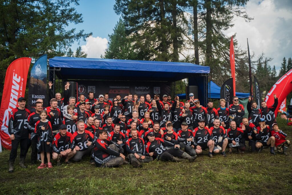 Group photo of the team in uniform in front of a tent