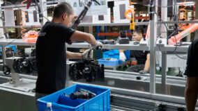 Worker assembling an engine on the conveyor