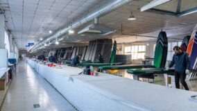 Long workshop with a board assembly line