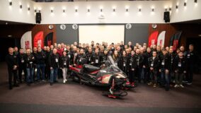 MDV Group team with a snowmobile